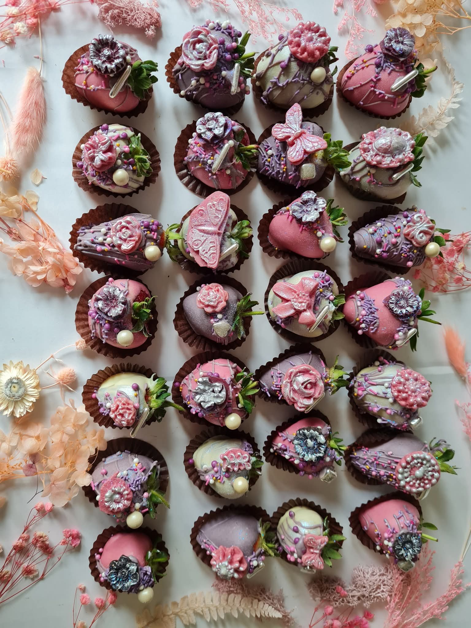 Handcrafted chocolate dipped strawberries with floral decorations