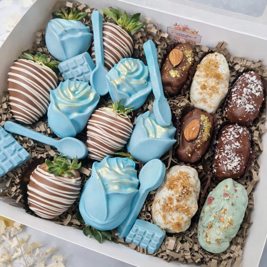 Blue-themed luxury chocolate treat box with drizzled strawberries, chocolate roses, and assorted chocolate-covered dates